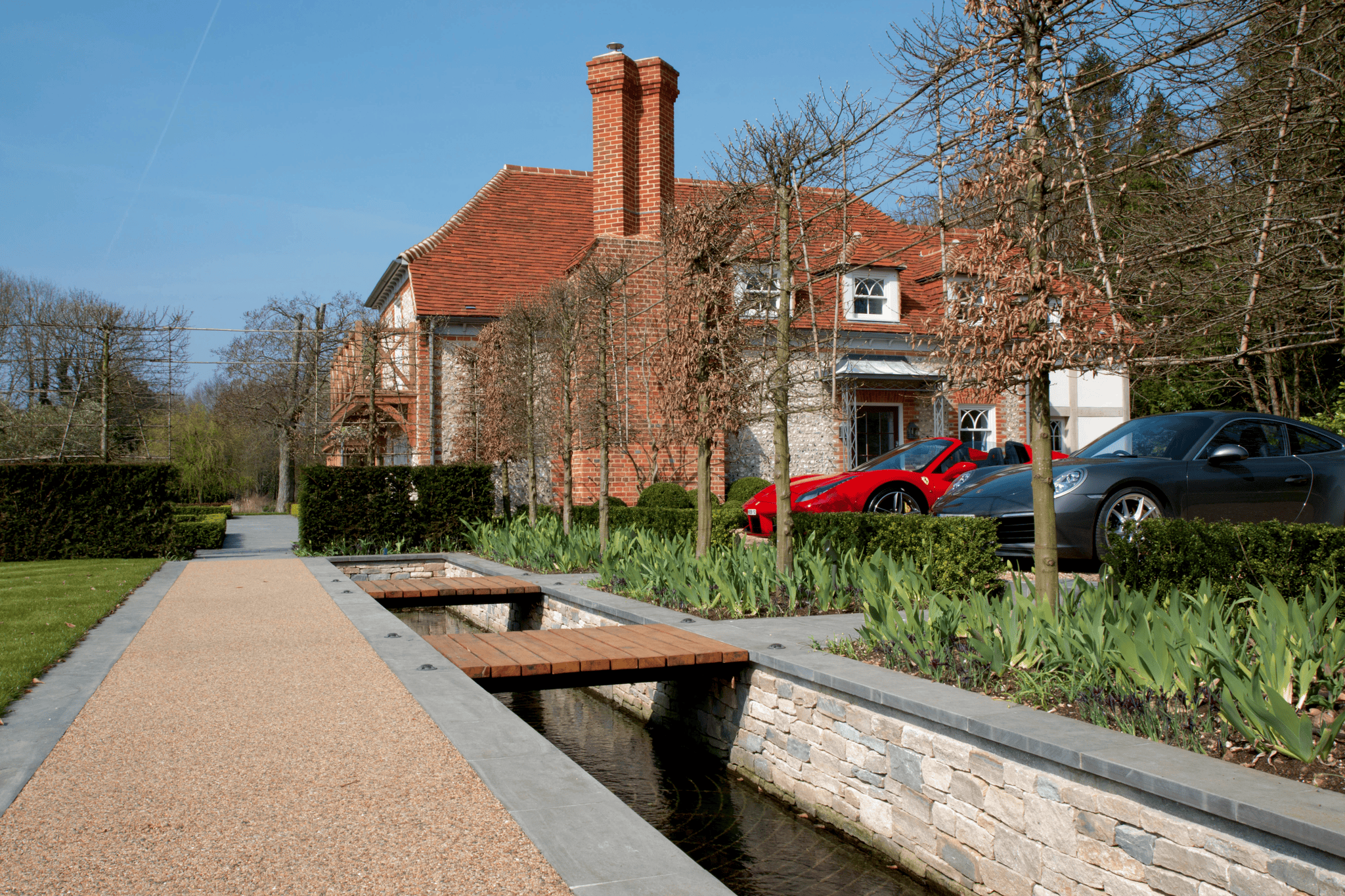 Cars parked on driveway next to planting