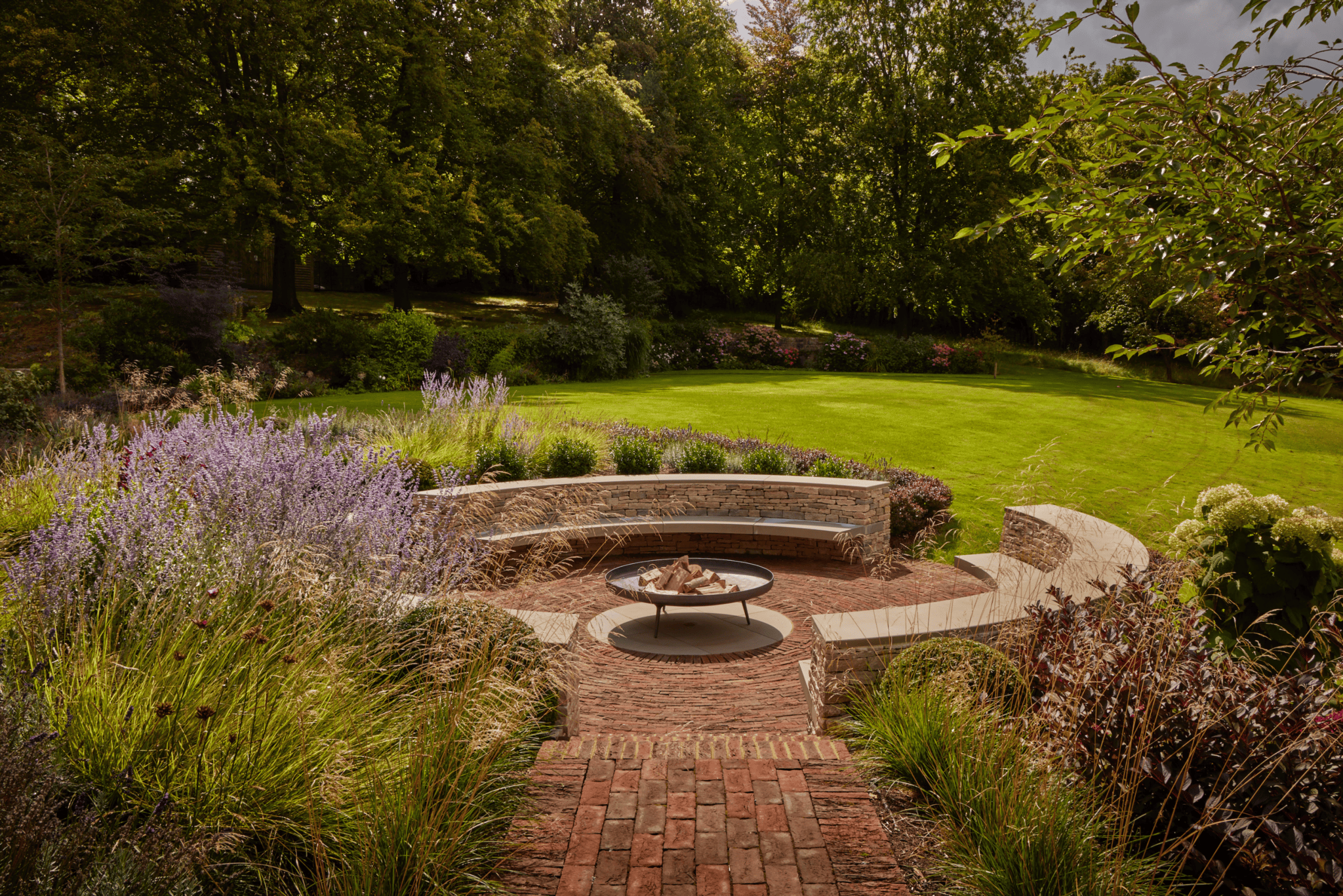 Fire pit seating next to a lawn