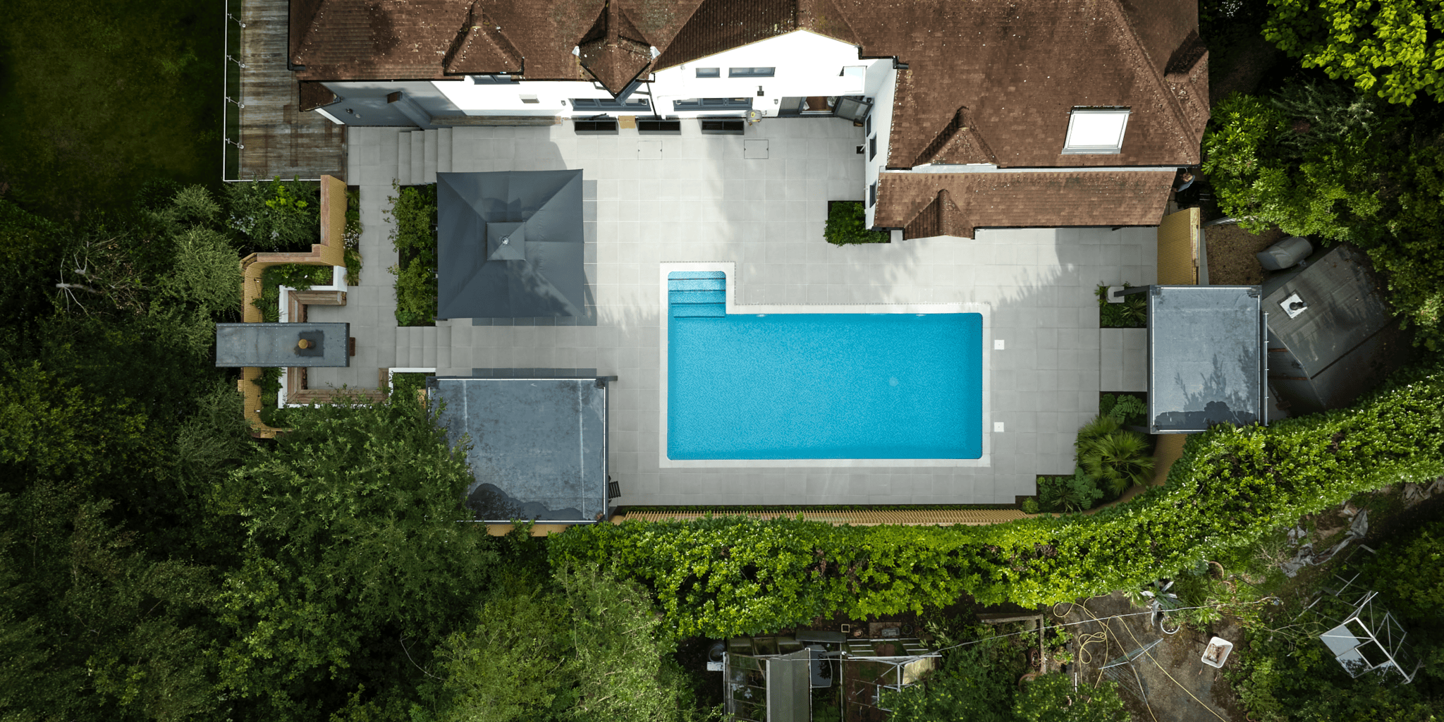 Poolside materials should balance safety, comfort and a refined finish.