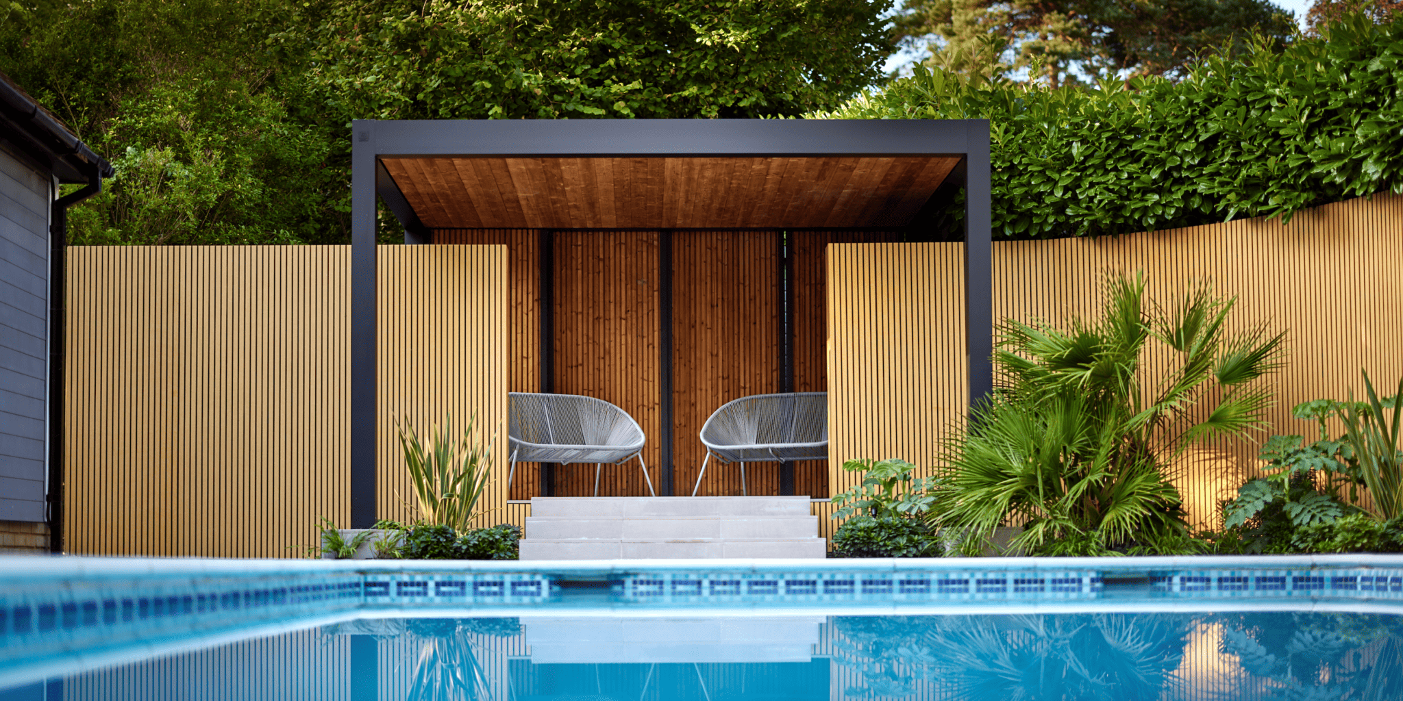 Carefully chosen planting helps a swimming pool feel settled within the garden.